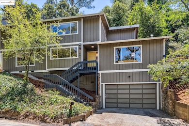 View of front of property featuring an attached garage and driveway