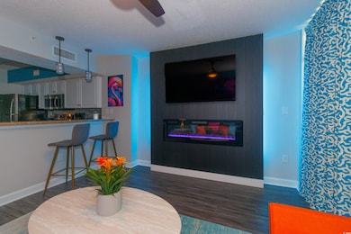 Living room featuring dark wood-type flooring, a t