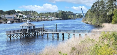 Dock area featuring a water view, a gazebo, and a 