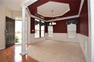 The Dining Room is on the front of the home. Nice tray ceiling and wainscot molding. Blinds on the windows.