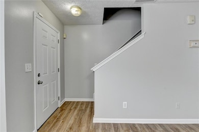 Entryway featuring wood finished floors, a texture
