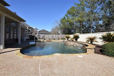 Enjoy a beautiful resort style backyard with a sparkling saltwater pool with raised stacked stone water features.