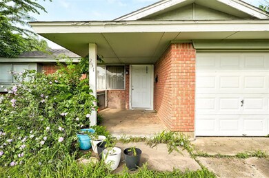 Doorway to property with a garage