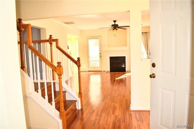 Foyer featuring ornamental molding, light wood-typ
