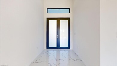 Entryway featuring marble tiled floors and baseboards