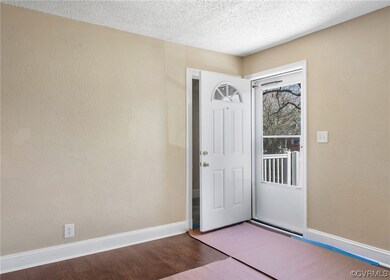 Foyer entrance featuring dark wood-type flooring and a textured ceiling