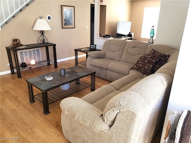 Living area with wood finished floors and stairs