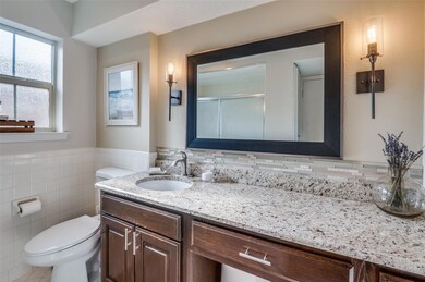 Bathroom with vanity, backsplash, tile walls, and 
