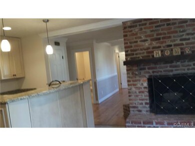 A fireplace in the breakfast room? Yes, there suer is!  One can see the hall half bath, the storage closet and the pantry from here.