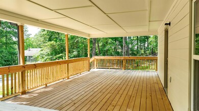 Wooden terrace with view of wooded area