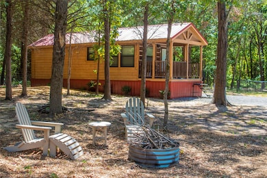 View of property exterior featuring a metal roof and a porch