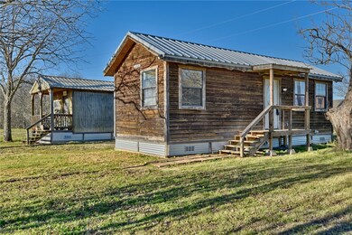 Back of house featuring a yard and metal roof