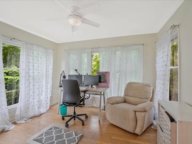 Office area featuring healthy amount of natural light, wood finished floors, and ceiling fan
