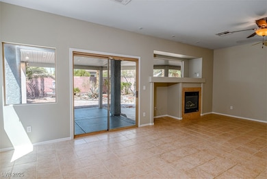 Unfurnished living room featuring light tile patterned floors, a ceiling fan, and a tile fireplace