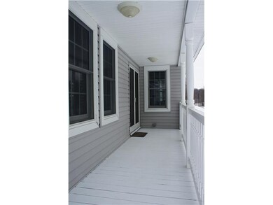 Exterior Front. A large covered front porch leads 