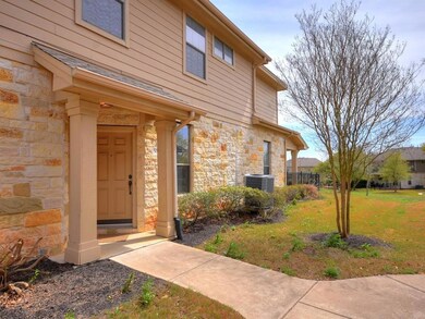 Doorway to property with a yard, stone siding, an