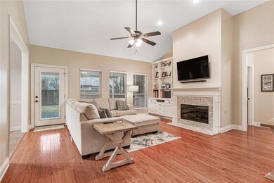 Bright living room features wall of windows, 12' c