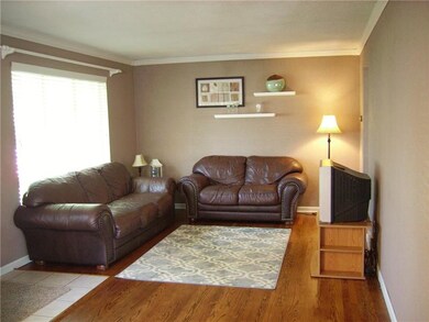 Spacious living room with hardwood floors.
