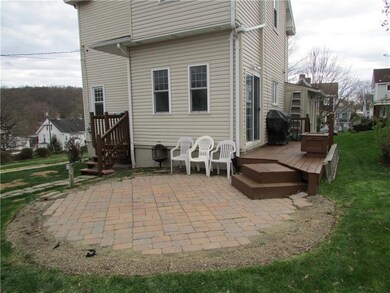 REAR OF HOME WITH SIDE DECK AND WALK UP PORCH. BRI