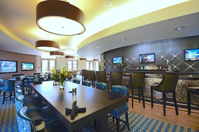 Dining area with indoor bar and wood-type flooring