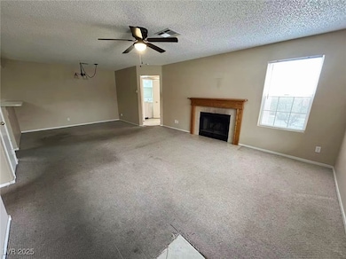 Unfurnished living room with a ceiling fan, a tile