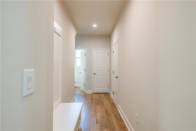 Corridor with light wood-type flooring