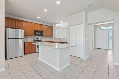 Kitchen featuring stainless steel appliances, lig
