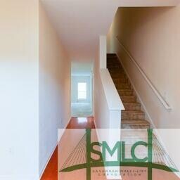 The foyer leads to the stairway to access the two 