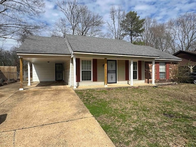 Single story home with an attached carport, covere