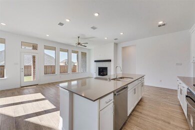 Kitchen featuring white cabinets, sink, stainless 