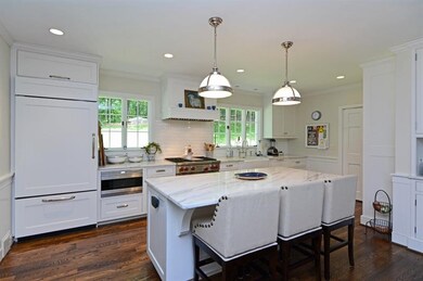 The light, neutral tones of the kitchen's marble c