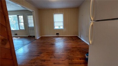 Spare room with dark wood-style flooring and healthy amount of natural light