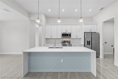 Kitchen featuring stainless steel appliances, a si
