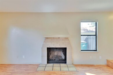 Detailed view of wood finished floors and a firep