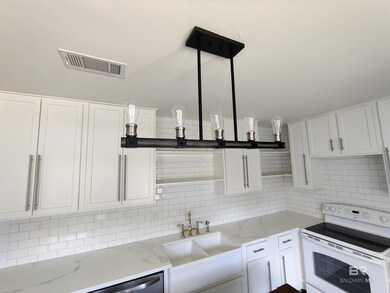 Kitchen with sink, white cabinetry, electric stove, opent shelving and backsplash