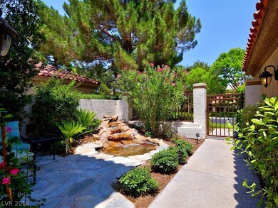 Front courtyard entry with lovely pond and waterfa