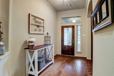 Wide foyer, beautiful front door with ornamental glass, arched entry to the formal dining room
