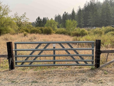 Gate with view of wooded area