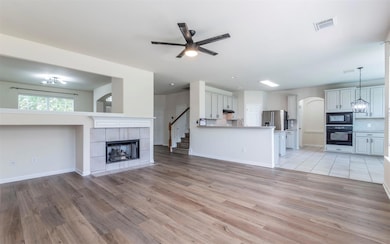 Unfurnished living room with ceiling fan, light w