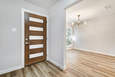 Entrance foyer featuring a chandelier, light wood