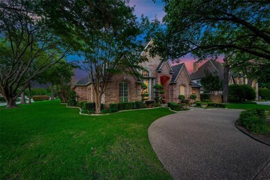 Lush landscaping and trees surround the home