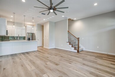 Unfurnished living room featuring ceiling fan, lig