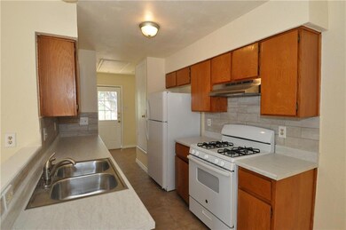 Kitchen with white appliances, under cabinet rang