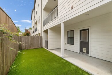 Another view of the covered patio and grassy yard