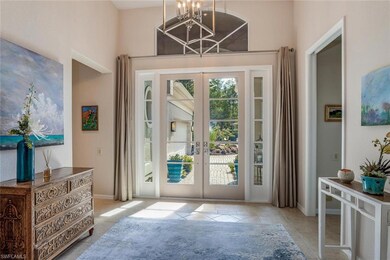 Entryway featuring french doors and a chandelier