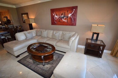 Living room featuring baseboards, ornamental moldi