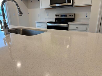 Kitchen with stainless steel appliances, white cab