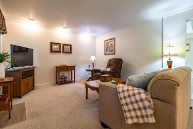 Living room with ornamental molding, a textured ce