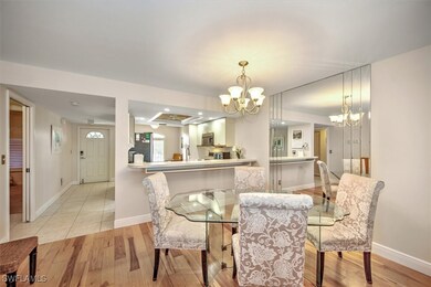 Dining area with a chandelier and light wood-type