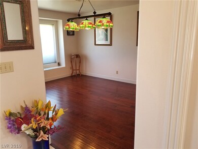 Formal living room with hardwood floor.  Light and